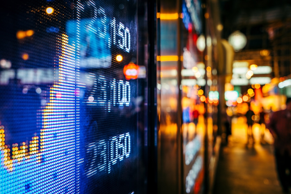 Display,Of,Stock,Market,Quotes,With,City,Scene,Reflect,On